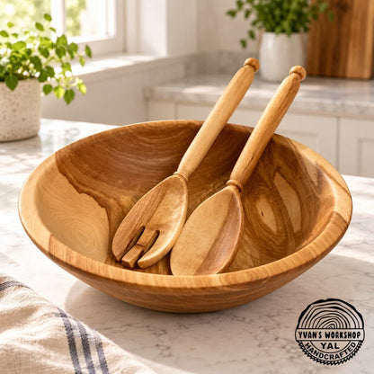 Wooden salad bowl beside its matching solid spoon and slotted serving spoon