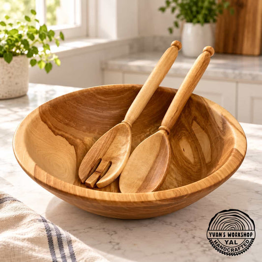 Wooden salad bowl beside its matching solid spoon and slotted serving spoon