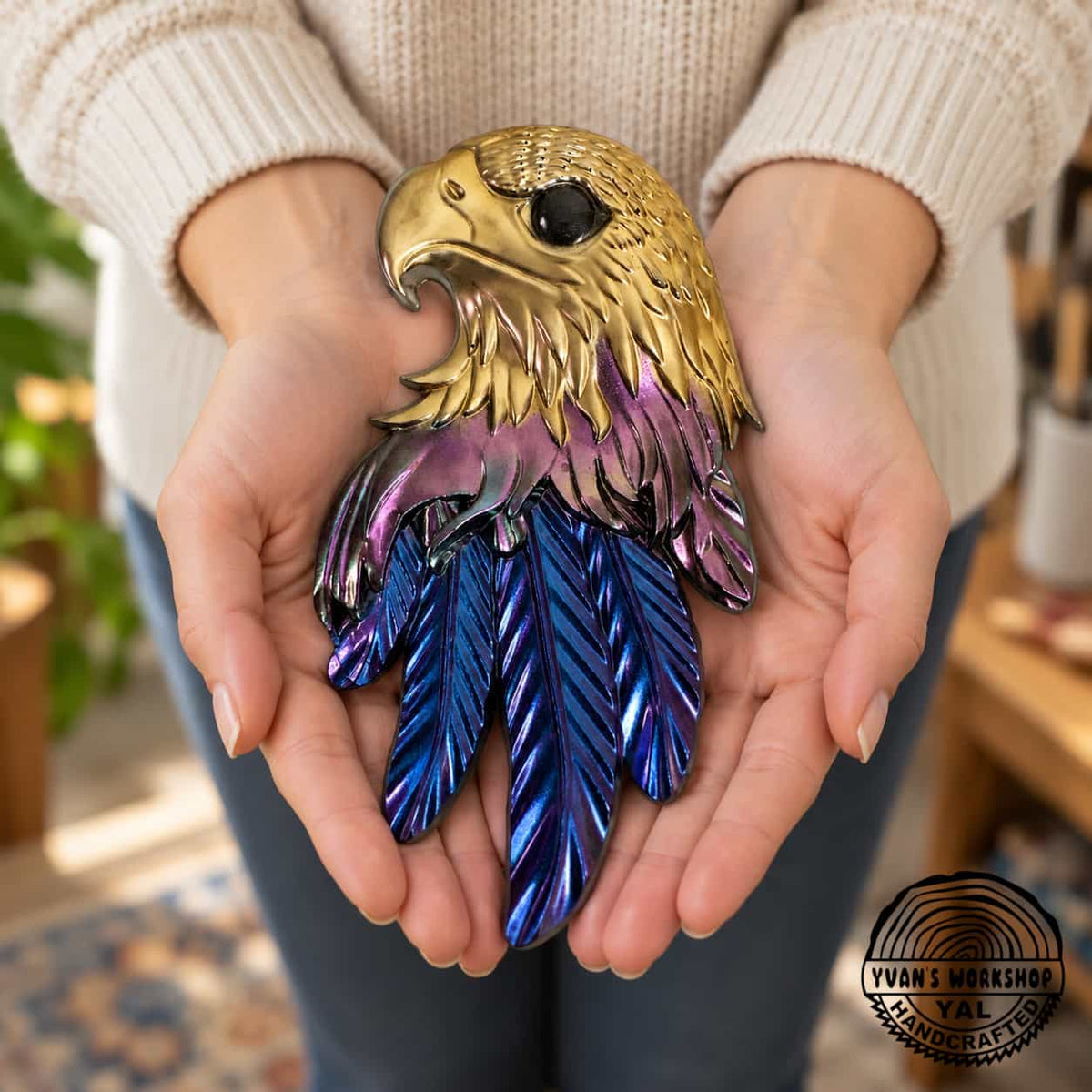 Gold eagle head ornament with purple middle feathers and dark violet lower feathers