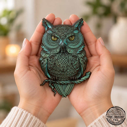 Teal metallic owl perched on a branch with detailed carved decoration